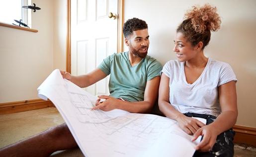 A couple planning home improvements with blueprints